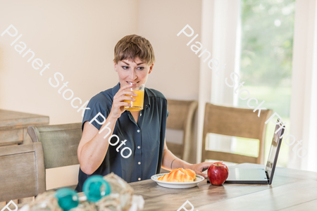 A young lady having a healthy breakfast stock photo with image ID: a900f332-1beb-43b6-a35d-ced04a38e0c2