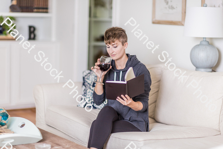 A young lady sitting on the couch stock photo with image ID: aea98985-2393-412b-a836-c2cccc7e20da
