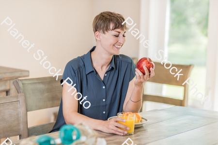 A young lady having a healthy breakfast stock photo with image ID: b15e6a24-b80e-48b0-b798-400c292ffbbd