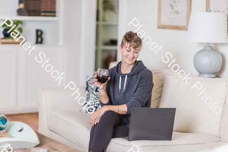 A young lady sitting on the couch stock photo with image ID: b28365f6-6a09-4df3-9c1a-254f4bfd2f63
