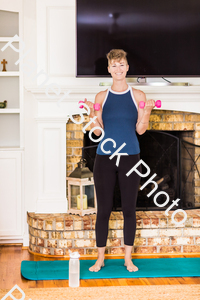 A young lady working out at home stock photo with image ID: babcf2b8-9933-4fb4-b35f-fd577d63e4a4