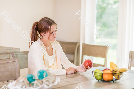 A young lady grabbing fruit stock photo with image ID: be827c2a-2d57-4cb2-a2ba-3b8ebb29d787