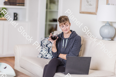 A young lady sitting on the couch stock photo with image ID: bf5ace1c-c524-4859-b8dd-1208967785d0