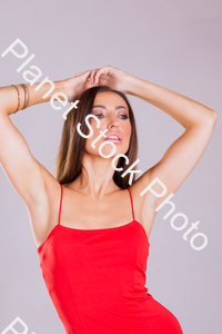Model in red dress, posing for a studio photoshoot stock photo with image ID: c2f9621d-84f2-401d-8515-24997693acc1