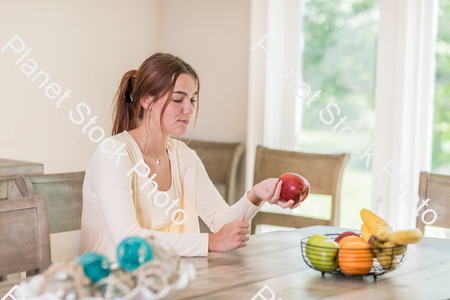 A young lady grabbing fruit stock photo with image ID: c488eb3c-5fce-4205-ab5f-b6b46d4debd6