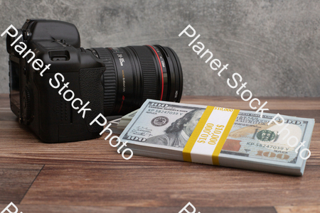 Three stacks of dollar-bills,  with a digital DSLR camera stock photo with image ID: c640196f-296d-484c-92a4-1def37c2a90e
