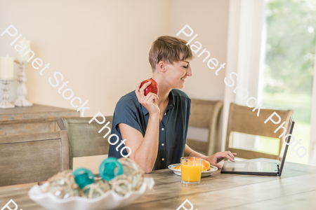A young lady having a healthy breakfast stock photo with image ID: c7bf2c5a-3010-4d89-a9e7-e37df03e6bbd