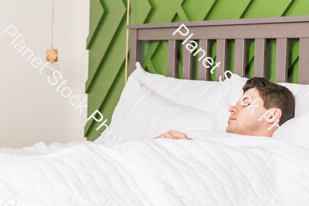A young man sleeping in bed stock photo with image ID: d422f6d1-3d67-40a8-a9e7-7096f6a3eb50