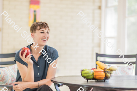 A young lady enjoying daylight at home stock photo with image ID: d6f5aeca-7681-4644-a2b6-d4d8ff674e07