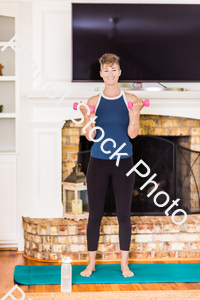 A young lady working out at home stock photo with image ID: db2cf3b1-f4c4-47c9-a3e2-406de3bbc8d3