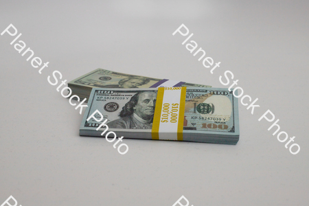 Three stacks of dollar bills stock photo with image ID: e544c6dd-9d51-41e6-9c52-604e72a9faa4