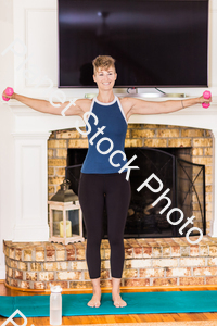 A young lady working out at home stock photo with image ID: e89d7cb6-9cdb-46a8-964f-38a88af4c93f