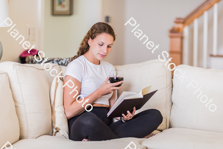 A young lady sitting on the couch stock photo with image ID: e946f1d9-5bec-449f-84c8-b12673a98dca