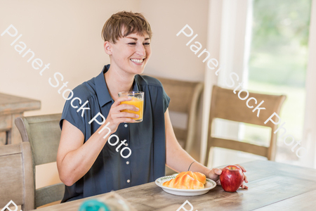 A young lady having a healthy breakfast stock photo with image ID: e9becea5-9257-4fcb-9766-d9e931bfccf9