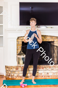 A young lady working out at home stock photo with image ID: e9bf18bf-1528-4d27-bbfc-df660a2d19e1