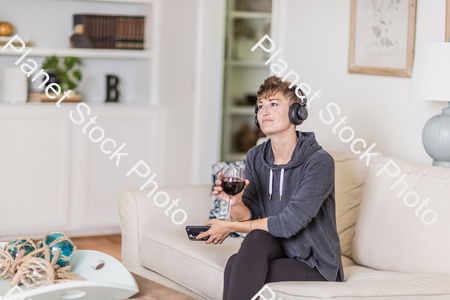 A young lady sitting on the couch stock photo with image ID: ea4fd469-f19c-4b83-93c4-40ee8bc36656