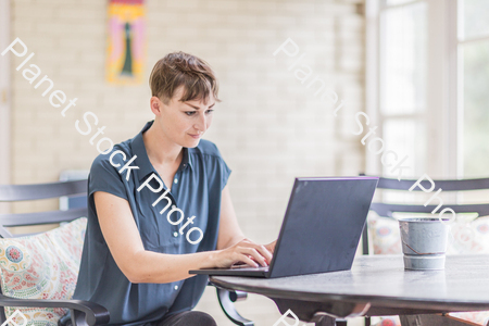 A young lady enjoying daylight at home stock photo with image ID: ebba1b42-9288-40a2-9c21-0bcd2ab4dbd7