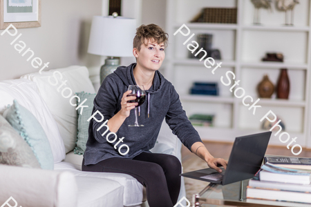 A young lady sitting on the couch stock photo with image ID: ec240ebd-231c-4fdd-a227-5fdba8b72d57