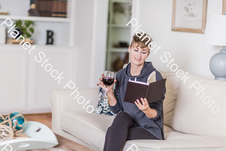 A young lady sitting on the couch stock photo with image ID: ec917a7a-7ce7-4cd7-b855-4845a446fa20
