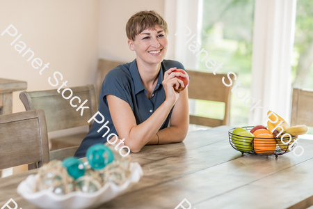 A young lady grabbing fruit stock photo with image ID: f16c4de9-58d4-46fd-a477-1b766e90f435