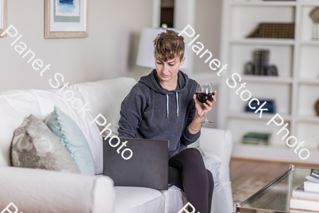 A young lady sitting on the couch stock photo with image ID: f22eff5e-b725-4645-b8fe-37a58cd78f40