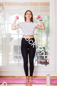A young lady working out at home stock photo with image ID: f731662a-bcfe-4ed1-8241-3584d98b843a