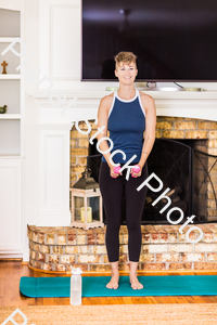 A young lady working out at home stock photo with image ID: fb638f8f-9e35-4a6c-a899-14160a5fd746