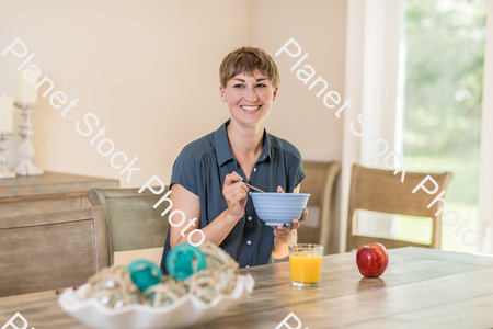 A young lady having a healthy breakfast stock photo with image ID: fde188b2-4f66-4203-979d-5e7dc3428e47