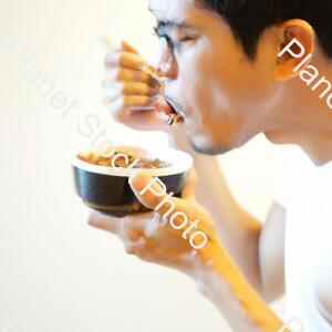 A Man Eating Food stock photo with image ID: ff23eb91-f3c4-4f6b-912a-1257bec9a9b1