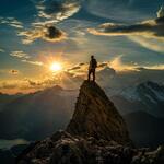 A Man Standing on the Top of a Amountain