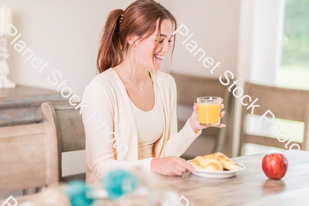 A young lady having a healthy breakfast stock photo with image ID: f6a7f17a-bf26-4fd0-983a-5322a04f46fa