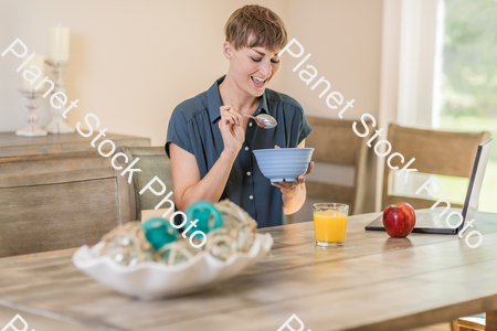 A young lady having a healthy breakfast stock photo with image ID: 6235a7f2-ed66-4348-989f-1827a38a5179