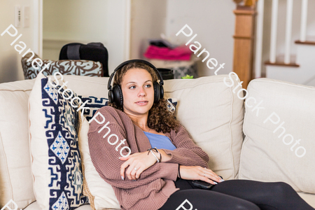 A young lady sitting on the couch stock photo with image ID: 3173c25e-3243-492f-879f-28b2d45399eb