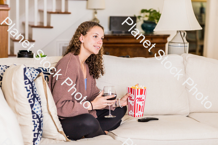 A young lady sitting on the couch stock photo with image ID: 89415c3d-b229-4c17-8506-5d0cdb563d59