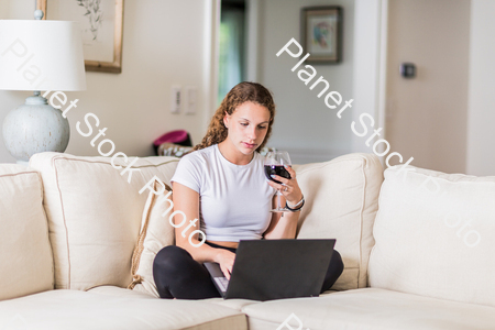 A young lady sitting on the couch stock photo with image ID: bcc103f8-59b9-494d-8eaf-186173132134