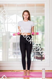 A young lady working out at home stock photo with image ID: 23ad11ef-14cb-464a-aefe-1231296df997