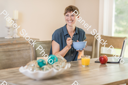 A young lady having a healthy breakfast stock photo with image ID: 615aa63e-d38b-40da-b3f2-a81de0272531