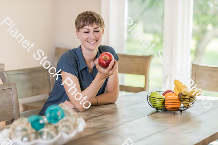 A young lady grabbing fruit stock photo with image ID: 1334d8a3-a5ae-442e-8872-cdcd56ef55fb