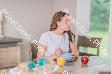 A young lady having a healthy breakfast stock photo with image ID: bd6954ac-8d35-47a3-a653-cd06a8994be7