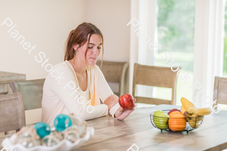 A young lady grabbing fruit stock photo with image ID: f1d8815c-ad4c-4d31-8617-771dee8a2077