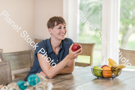A young lady grabbing fruit stock photo with image ID: 2b8cd47d-c4c3-4d74-af7e-36cb69569e59