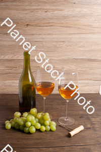 One bottle of white wine, with wine glasses, corkscrew, and grapes stock photo with image ID: b4053065-17e8-4f57-8ca8-66295319a646