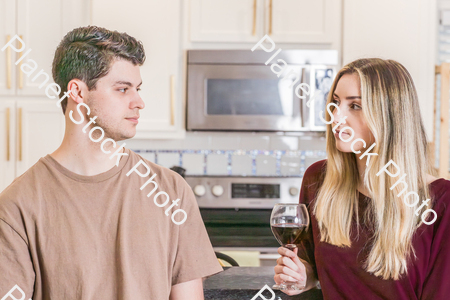 A young couple sitting and enjoying red wine stock photo with image ID: 03d6f207-c0ec-48b6-8848-6db033ec905d