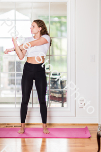 A young lady working out at home stock photo with image ID: 4082f84c-4b31-4537-a16e-d9c7804f76a1