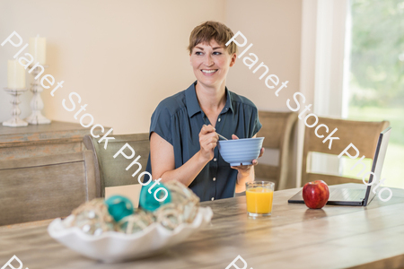 A young lady having a healthy breakfast stock photo with image ID: ac95f75d-5b8f-4c2d-b5ef-5e0ca2c4ac38