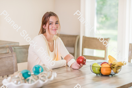 A young lady grabbing fruit stock photo with image ID: f7b9e204-1285-435a-96c1-981545cecb83