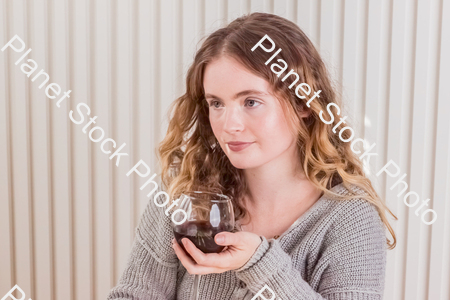 A girl sitting at the table, enjoying red wine stock photo with image ID: b5ced723-8a21-48b7-bb00-a18ddfae249a