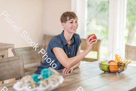 A young lady grabbing fruit stock photo with image ID: 4db69061-218b-436a-8623-6cd77bf13a50