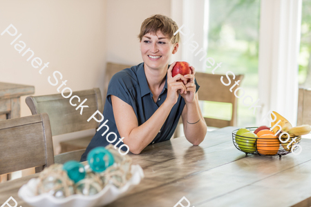 A young lady grabbing fruit stock photo with image ID: 3cecfffa-ebf2-4d1e-825a-cc2c88578d44