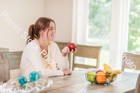 A young lady grabbing fruit stock photo with image ID: 64c9bf09-1755-4d76-a1ca-4a0ea5682d4d